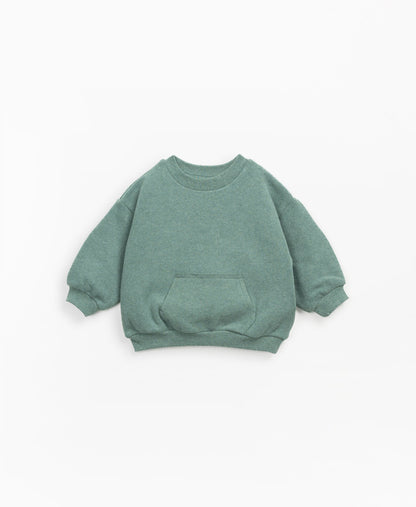 Dieser Pullover mit Jersey-Stich besteht aus einer Mischung aus Bio-Baumwolle und Baumwolle in der Farbe Minho Melange. Dieses Modell hat einen Rundhalsausschnitt, Fleece innen, eine elastische Taille und Manschetten und eine Kängurutasche auf der Vorderseite.